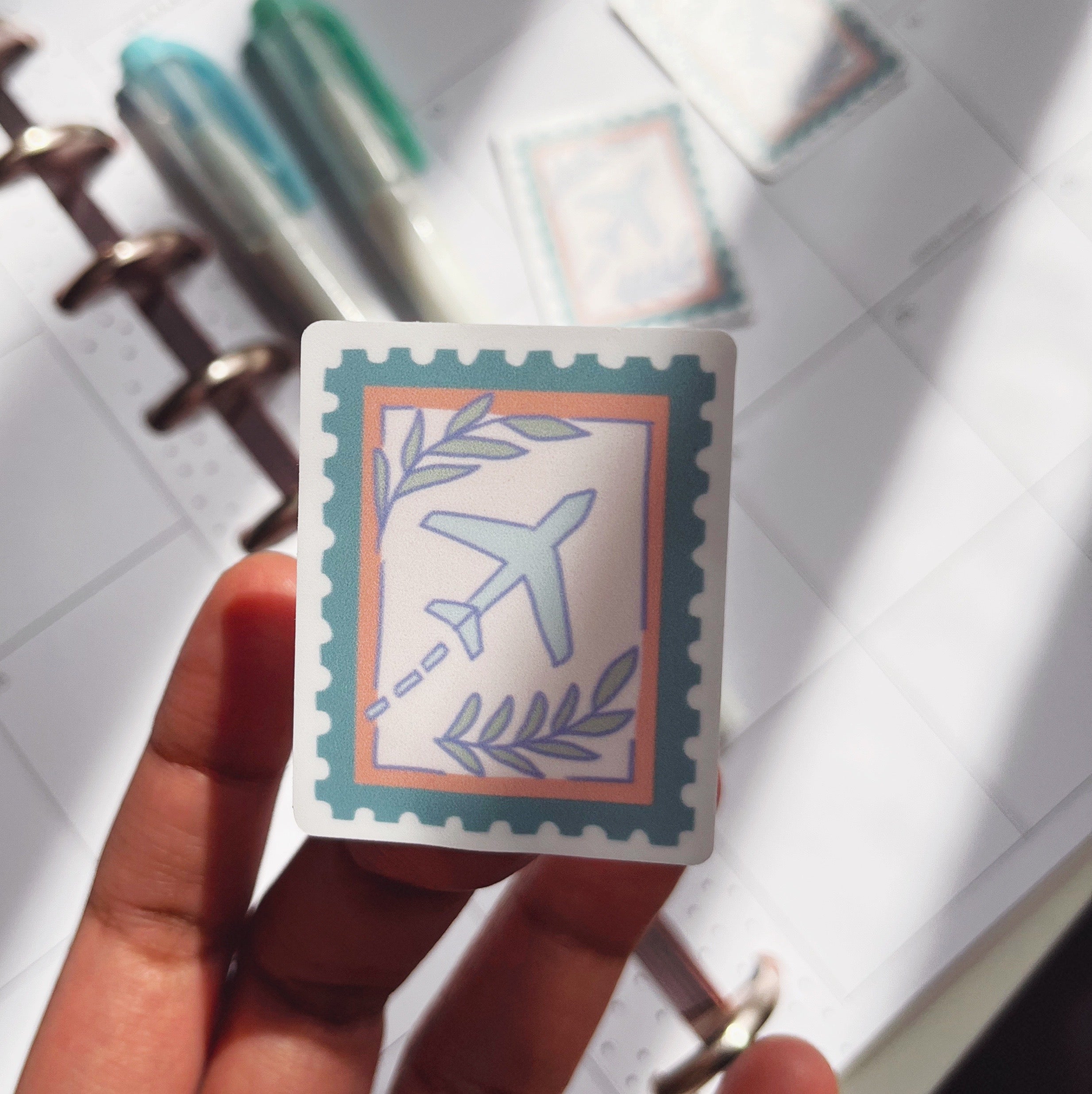 A sticker of an airplane designed to look like a vintage stamp.